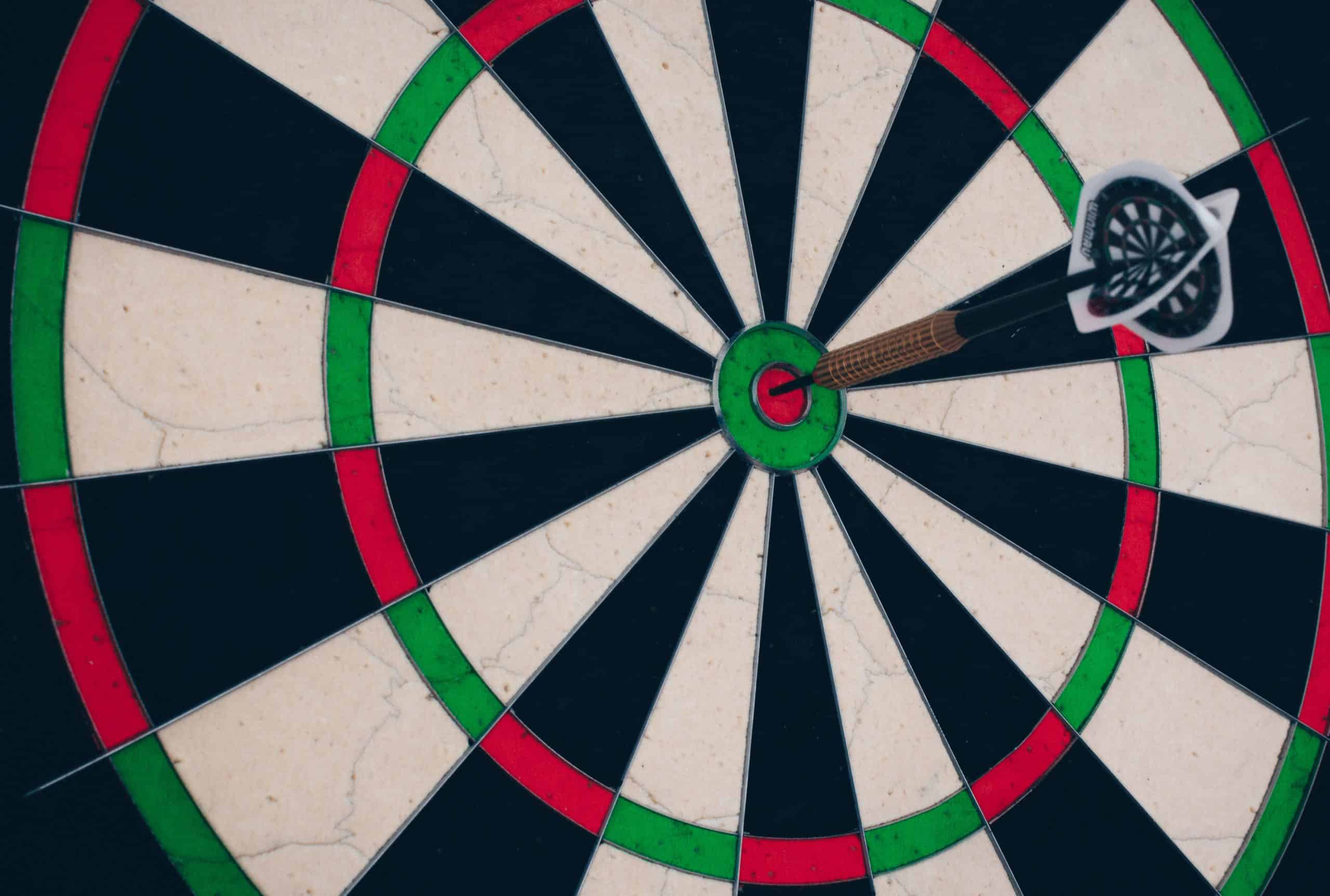 A dart is in the center of a dart board.