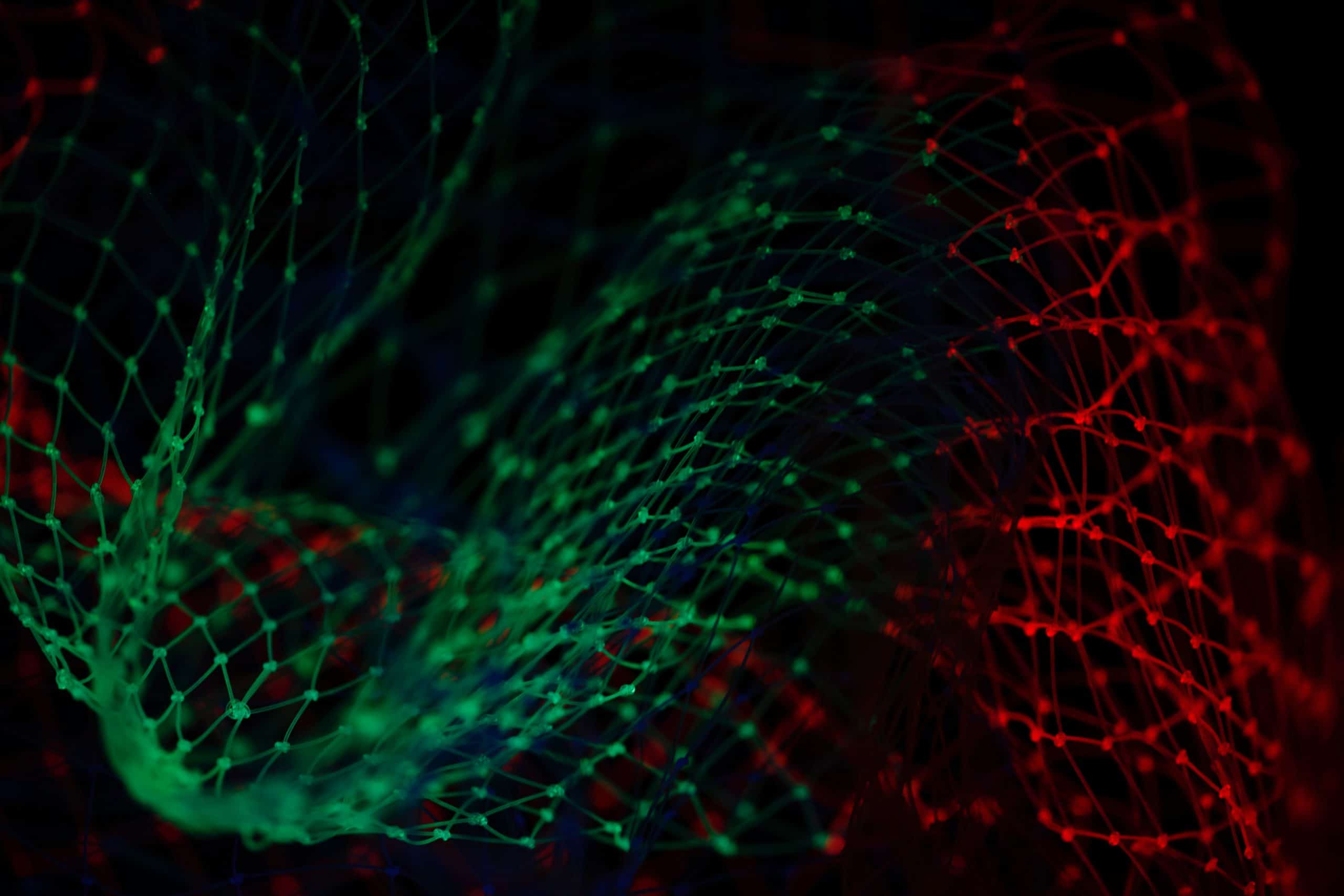 A close up of a green and red net.