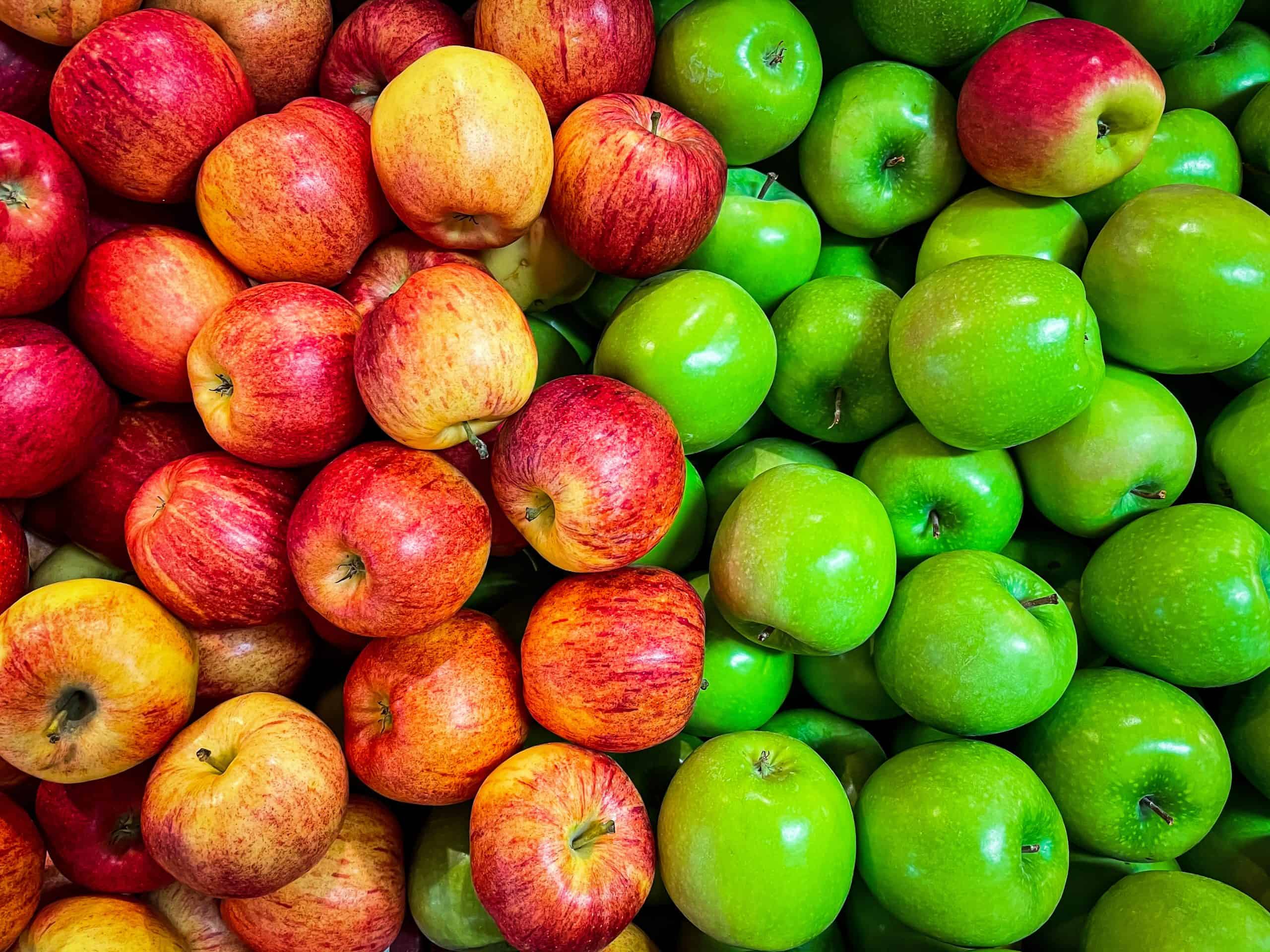 A pile of red, green, and yellow apples.